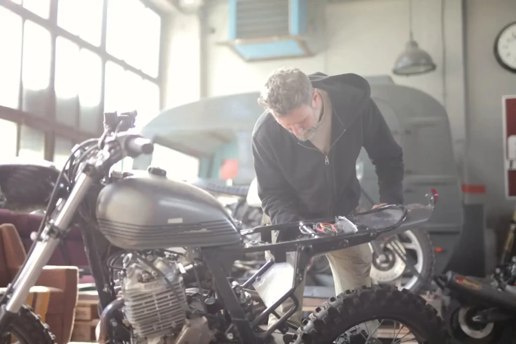 man checking his motorbike seat for riding